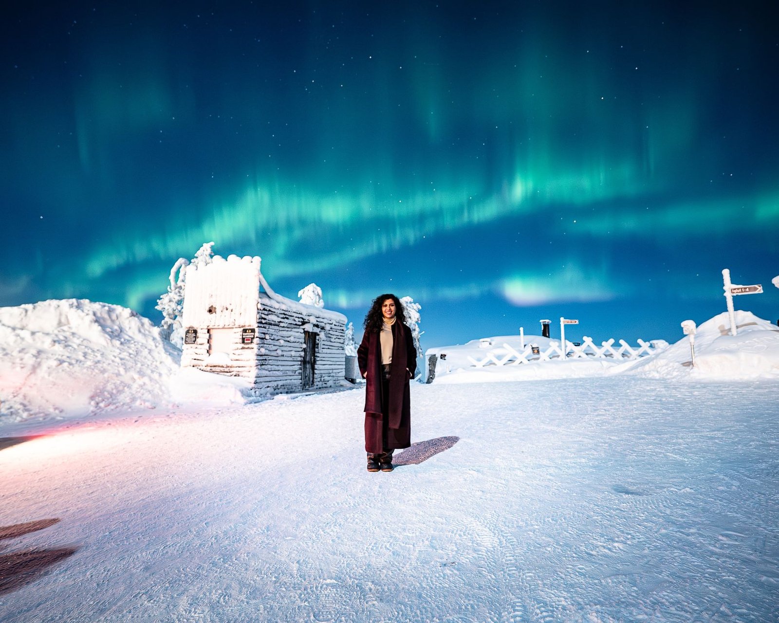 Northern lights portrait on a snowy fell top in Lapland
